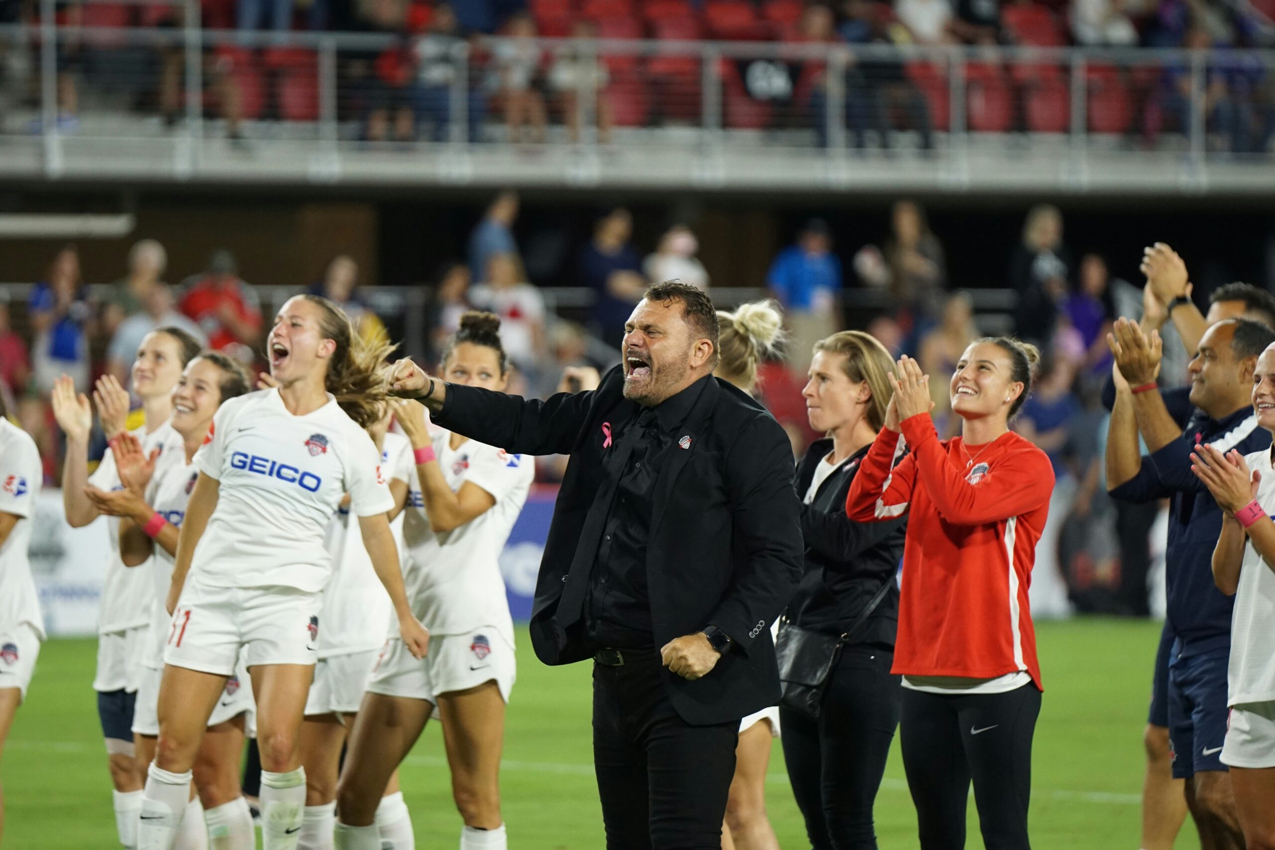 A team of female soccer players celebrating alongside their coach: soccer mental Skills