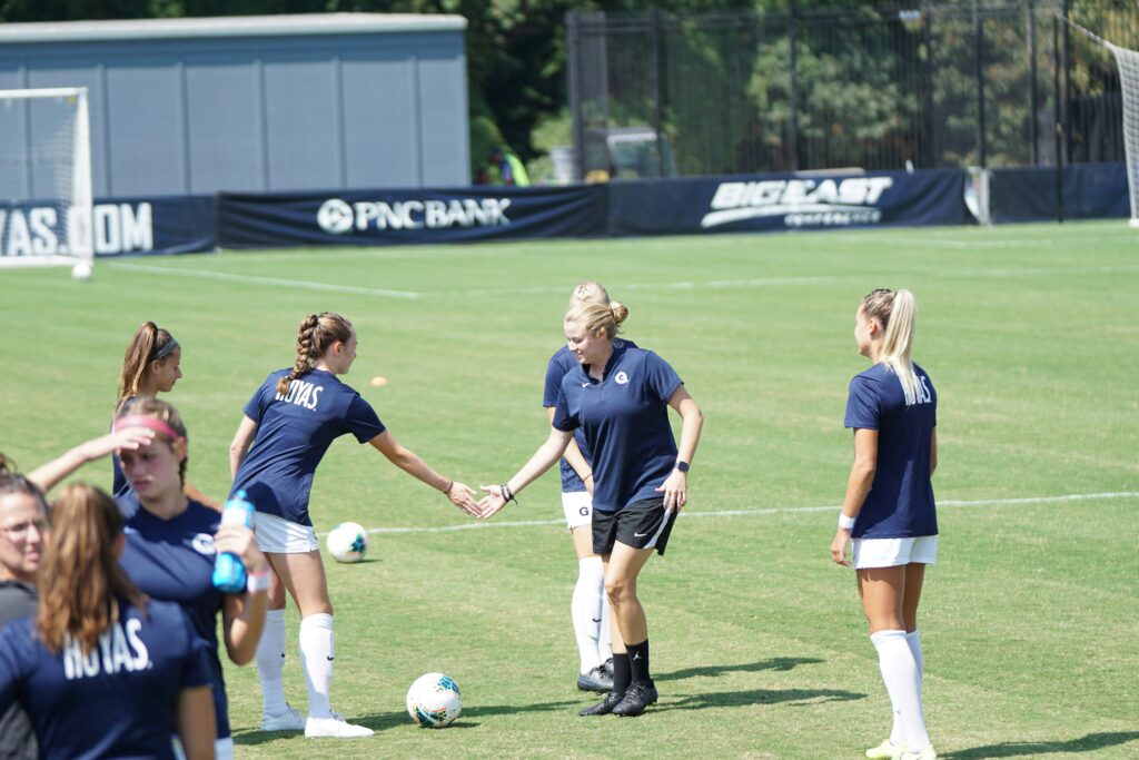 Female footballer alongside her coaching: Best Soccer Support System 