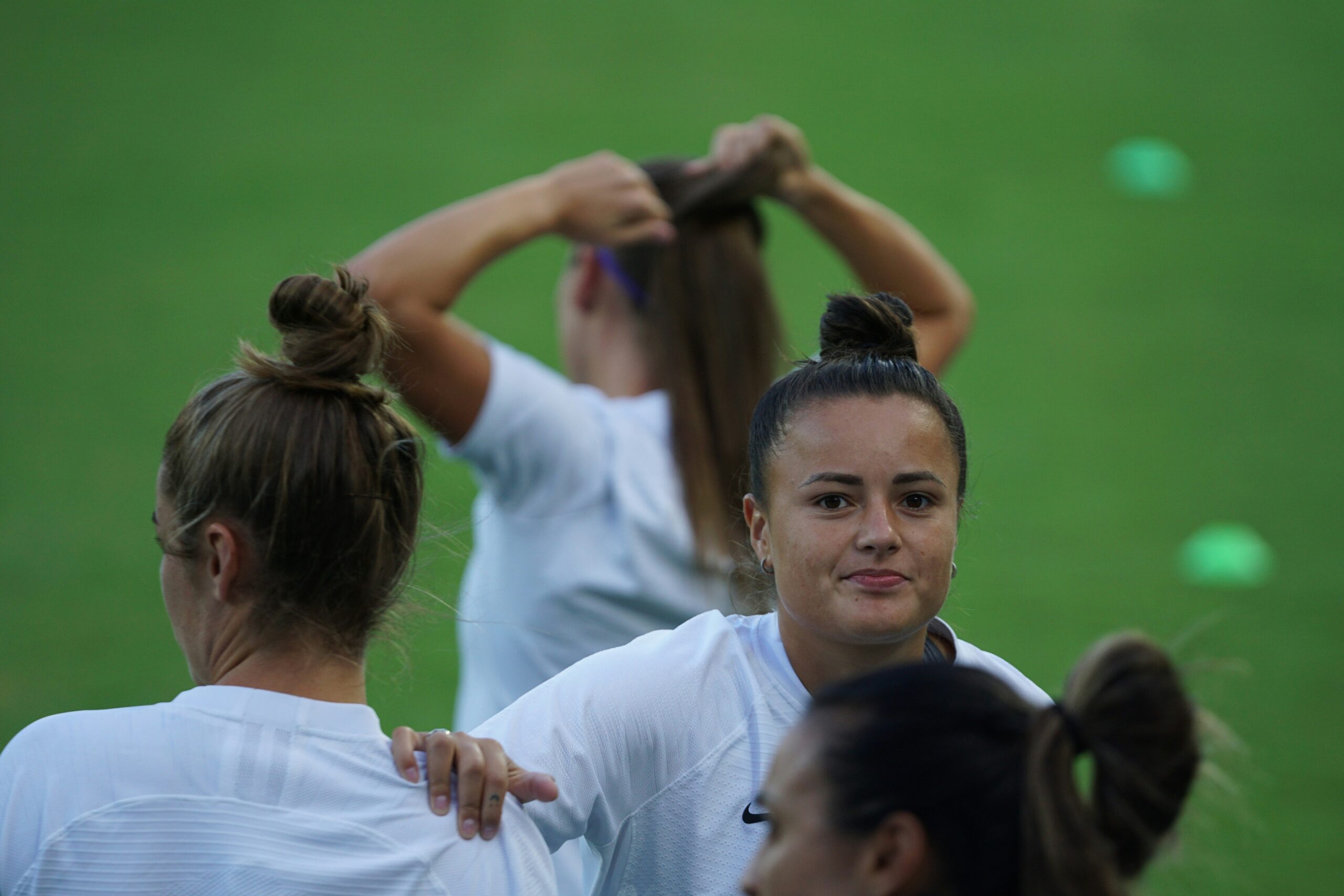 A female footballer looking forward leaning into her teammate shoulder: Mental Fitness Drills
