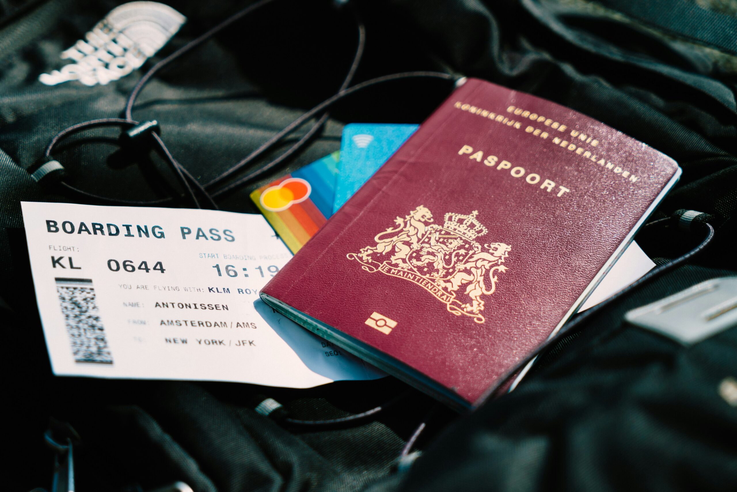 A passport and a boarding pass placed on top of a bag: Destinations to Explore This Festive Season