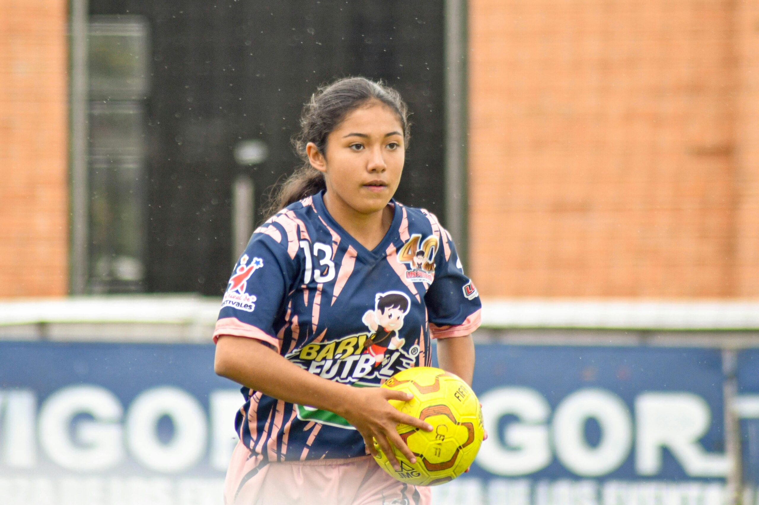 A soccer girl with a soccer ball wanting to do a throw-in: Soccer Throw-In