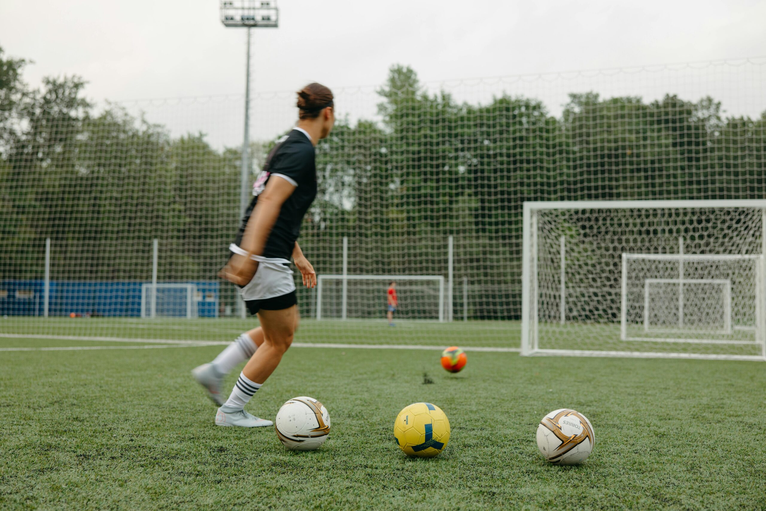 a women in black shirt palying women soccer: soccer penalty