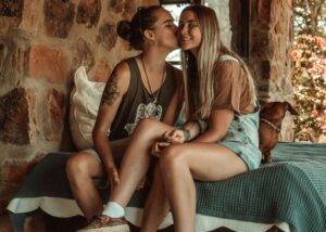 Picture of a waoman kissing another woman on the cheek: USA gay female soccer players