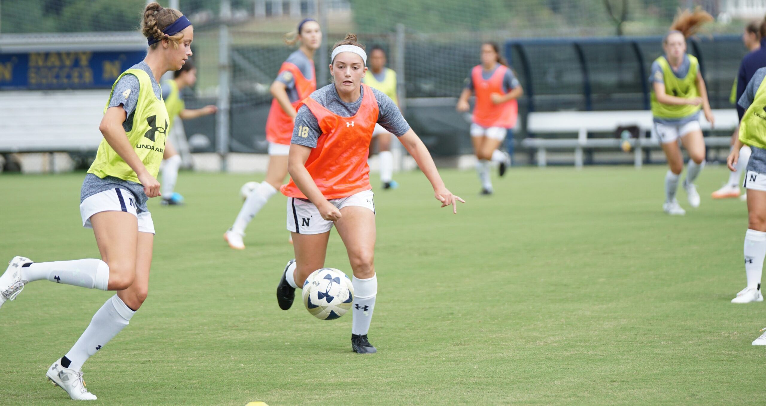 A group of women footballers training on playing soccer on green pitch during daytime: What Is a Good Soccer Position for Me?