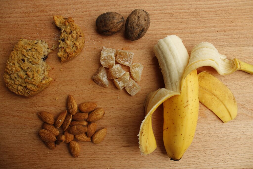 sliced banana and brown nuts on brown wooden table: what to eat for soccer
