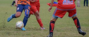 Teenage girls playing a match during daytime nutmeg in women's soccer